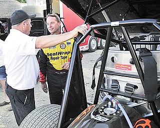 NASCAR driver Dave Blaney talks to a member of his race team after a hot laps race Tuesday night at the Sharon Speedway.