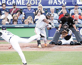 The National League’s Pablo Sandoval, of the San Francisco Giants, hits a three-run triple on a pitch by the American League’s Justin Verlander, of the Detroit Tigers, in the first inning of the MLB All-Star game Tuesday in Kansas City, Mo.