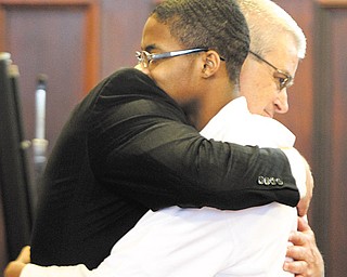 Shonqualin Hendrix, 16, hugs his attorney Mark Lavelle immediately after a jury of seven men and five women
cleared him of murder charges in Mahoning County Common Pleas Court.