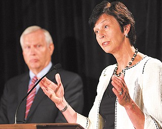 Karen Peetz, chairwoman of the Penn State Board of Trustees, talks as Rodney Erickson, left, university president, listens in during a news conference at the Hilton Hotel in Scranton, Pa. Board members answered questions after the Freeh Report on the sex scandal implicated university officials Thursday.