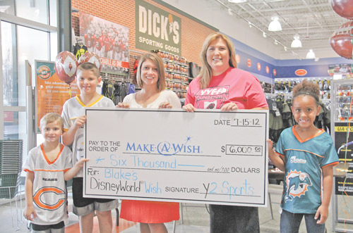 Luke Porter, 5, of Austintown; Gavin Porter, 10, of Austintown; Kim Sazima, of the Make A Wish Foundation, Amy Giles, league organizer for YYFFA; and Alexis Giles of Poland hold a $6,000 check given to the Make A Wish Foundation by participants in the Youngstown Youth Flag Football Association.