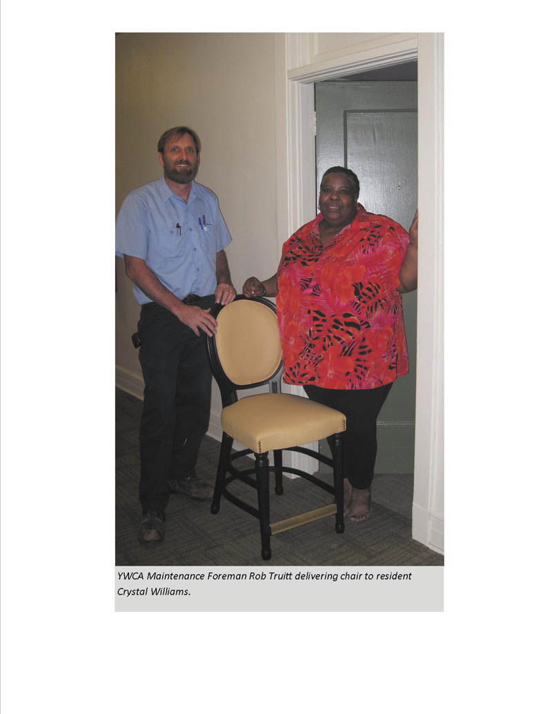 Rob Truitt, YWCA maintenance foreman, delivers a chair from the Gasser Chair Co. to Crystal Williams, a resident in YWCA of Youngstown permanent supportive housing. Mark Gasser, company president, made the donation of 48 chairs for use in YWCA apartments on Rayen Avenue in Youngstown for low-income and homeless individuals. Leah Brooks, interim executive director, said the YWCA recently completed renovation and historic preservation of the YWCA building and the chairs with dark wooden trim and butterscotch color match the historic color palette. The YWCA and community donations help furnish apartments.  
