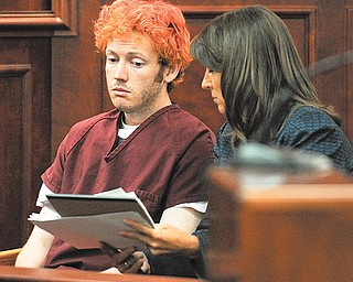 Public Defender Tamara Brady shows James E. Holmes documents as he appears in Arapahoe County District
Court on Monday in Centennial, Colo.