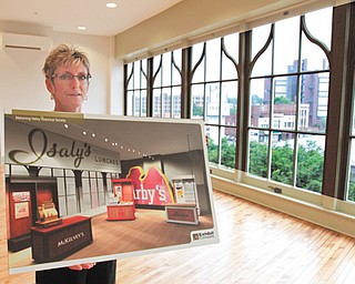 Cheryl Lewis, the Mahoning Valley Historical Society’s campaign director, shows plans for the third floor of the Tyler Mahoning Valley History Center. The floor will feature portable hands-on exhibits from some of the city’s iconic businesses, including Isaly’s, McKelvey’s and Arby’s.