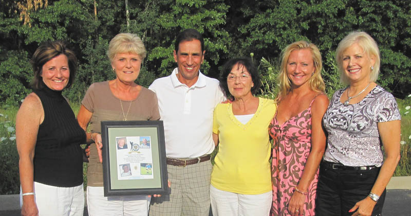 Vickie Maietta, second from left, holds a remembrance frame with the photos of Youngstown Police Department officers who died of cancer in the past year and a half and who were honored at the 21st annual charity golf benefit June 22 at Pine Lakes Golf Course in Hubbard. She and other committee members, from left, Sue Centorame, Fred LoSasso, Carlotta Kane, Laura Brown and Debra DeMatteo, arranged the benefit, dedicated to Capts. Kenny Centorame and Bob Kane and detective Sgts. Jerry Maietta and Joe DeMatteo. It raised more than $33,000, which will go to scholarships for children of YPD officers and civilians attending Youngstown State University. Other committee members were John Patton, Tony Tulipano, Tony Marzullo and Jerry Slattery. Contributing to the event’s success were platinum sponsors Dr. Denise Bobovnyik and Michael Bruno. Gold sponsors were Briarfield at the Ridge, Centorame, City Disposal Services, Denise DeBartolo-York, DeMatteo, Environmental Specialists, Kane, Vickie Maietta, Victor and Diane Perez, Harry Wollet, Youngstown Police Association, and Youngstown Police Ranking Officers, and silver sponsors were A.P. O’Horo, Dr. Vincent Paolone, Drs. James and Cynthia Kravec, the Rev. Edward Neroda, GLI Pool Products, HBK, Huntington Bank, Knoll Run Golf Course, Daryl and Luann Martin and family, Daryl and Vickie Mincey, Transit Service Inc., Jim Tressel, YSU Foundation and Ziegler Tire. The event attracted 144 golfers and had more than 25 prizes in the basket auction, a 50/50 drawing, IPAD raffle and dinner. Donations may be directed to Laura Brown at 330-742-8718 or email Labro63@aol.com. The next outing will be June 28, 2013, at Pine Lakes. 
