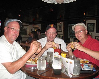 Mahoning Valley Burger Review Board members Scott Long, Jerry Tranovich and Anthony Fuda, enjoy their burgers at the Iron Bridge Inn.