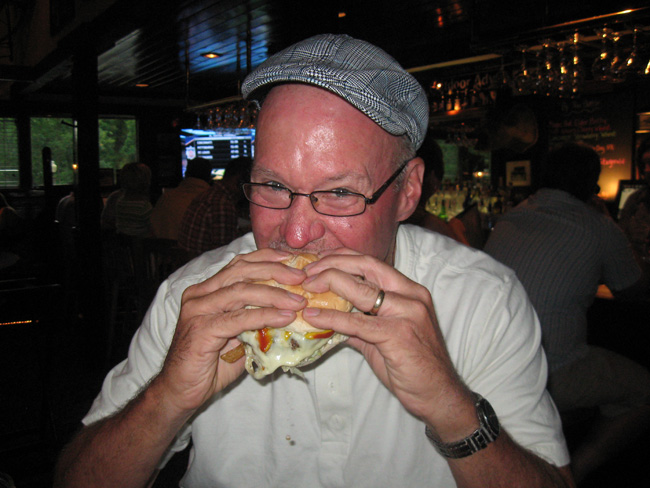 Scott Long takes a bite out of his Pittsburger at the Iron Bridge Inn.