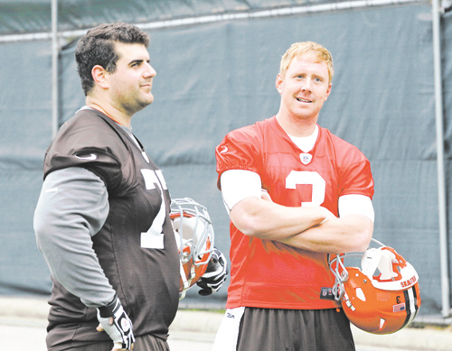 Browns rookie quarterback Brandon Weeden (3) chats with OL John Greco, a Boardman High grad, at a preseason practice. While Cleveland is counting on Weeden to make an immediate impact, coach Pat Shurmur is mum on which QB will get the starting nod.