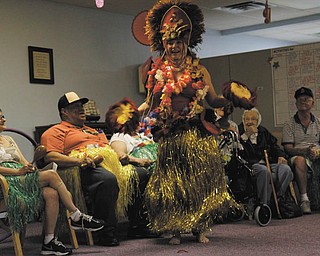Canfield resident Lana VanAuker just loves to dance. She says she dances everywhere she goes — Italy, Spain, Morocco, Hawaii and right here at home in Mahoning and Trumbull counties. Her most recent audience was a group of senior citizens at the Senior Independence adult day care in Boardman, where she donned a traditional Hawaiian costume and performed the hula. Photo by: MADELYN P. HASTINGS | THE VINDICATOR