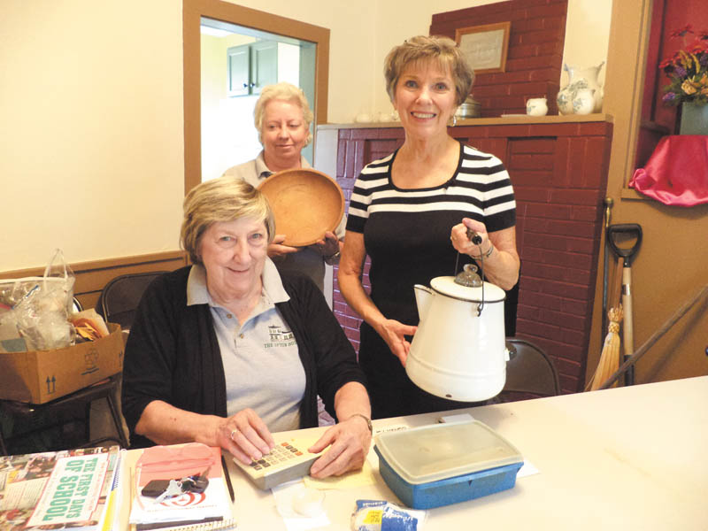 Carolyn Andrews, seated, and Sue Stoddart, left, and Kathy Lepro show some of the artifacts on display at the Upton House, 380 Mahoning Ave. NW, Warren, which is operated by the Harriet Taylor Upton Association. An open house is scheduled from 2 to 5 p.m. Sunday and will feature Waterford items. Carol Olson will host. The house is available for tours and rental for meetings, parties and events. Call 330-395-1840.
