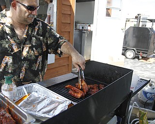 Mark DiRienzo grills ribs with his signature barbecue sauce at the fourth annual Rib Festival at Mastropietro Winery in Berlin Center, Ohio on July 21, 2012. This is his second year at the festival.