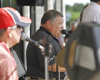 John Bilowus sings at the fourth annual ribs festival at the Mastropietro Winery in Berlin, Ohio for his band, 'Sounds Around Town' with other band members Gary Dirnisio and Mike Ianazone. 