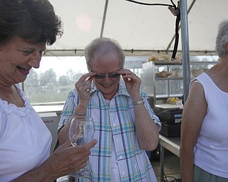 (L-R) Flo Arndt and Marilyn Carroll laugh as they try to decide what kind of ribs to eat at the Mastropietro Winery in Berlin Center, Ohio during the fourth annual ribs festival on July 21, 2012. 