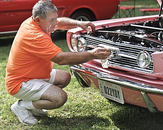 Sam Martuccio shines his daughter's car at the car show in Woodland Park in McDonald, Ohio. He built the 1966 Mustang for his daughter, Lucua Martuccio.
