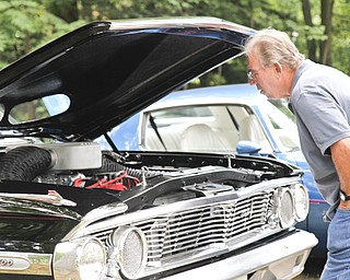 Bob Miller looks at a car at the car show in McDonald, Ohio.