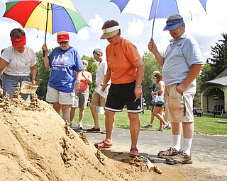 (L-R) Ida Krcelic, Louise Zombeck, Gladys Antonelli, and Walter Zombeck stand back to take a look at their sand sculpture at Mill Creek Park on July 29, 2012. 