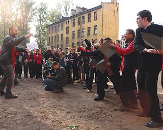 A complaints choir sings in a European city in this scene from a video that is part of the Living As Form exhibition.
