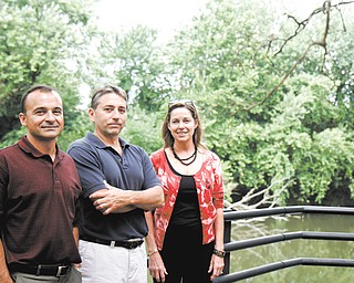(L-R) Pat Billett, John Kwolek, and Patricia Natalie make up 3 of the 5 Friends of the Mahoning River. They plan to fundraise for the cleaning of the Mahoning River to remove contaminated sediments and make it a more functional area. They are seen behind the B & O restaurant which has a direct view of the river in Youngstown, Ohio.