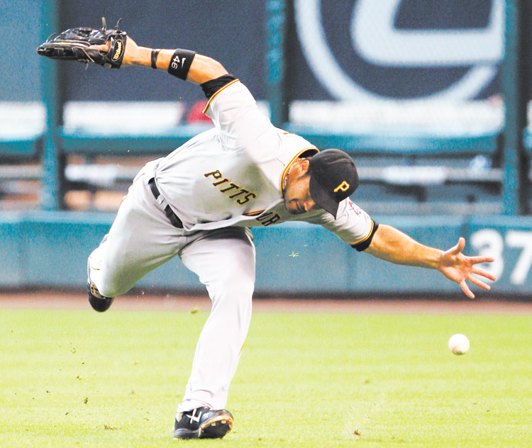 
Pittsburgh Pirates’ Garrett Jones (46) misses a catch allowing Houston Astros’ J. D. Martinez to triple in the fifth inning of a baseball game Sunday in Houston. The Astros won 9-5.
