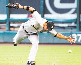 Pittsburgh Pirates’ Garrett Jones (46) misses a catch allowing Houston Astros’ J. D. Martinez to triple in the fifth inning of a baseball game Sunday in Houston. The Astros won 9-5.