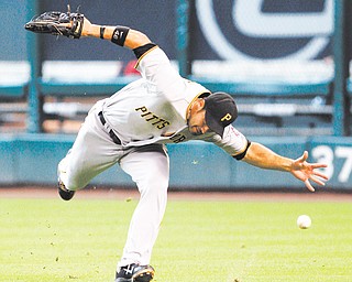 
Pittsburgh Pirates’ Garrett Jones (46) misses a catch allowing Houston Astros’ J. D. Martinez to triple in the fifth inning of a baseball game Sunday in Houston. The Astros won 9-5.
