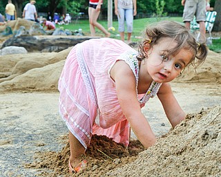 Veronika Aey, 2, plays in a pile of sand at the sand sculpture contest at Mill Creek Park in Youngstown, Ohio on July 29, 2012. 