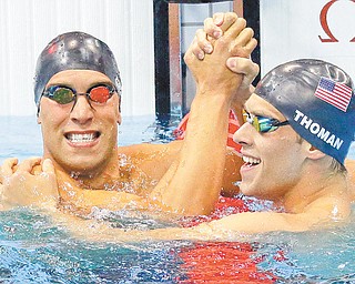 Americans Matthew Grevers, left, and Nick Thoman celebrate their gold and silver medal wins, respectively, in the men’s 100-meter backstroke swimming final Monday at the Aquatics Centre in the Olympic Park in London.