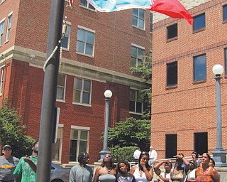 Family members of Zeboney Bess of Warren help raise the Victim’s Flag in front of the Trumbull County Sheriff ’s Office on Monday. Zeboney was 17 when she was killed by a gunshot to the head July 14 on Hamilton Street Southwest. Police have made no arrests.