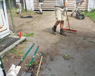Shovels and elbow grease - as the Americorps National Civil community Corps Team cleaning up the Idora Neighborhood as they worked at a house on Brentwood.