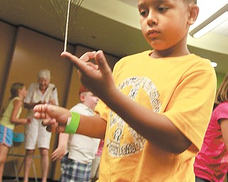 Caleb Sakara, 6, of Youngstown, practices his
balancing skills at the workshop.