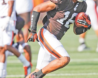 Cleveland Browns wide receiver Josh Cribbs returns a punt during training camp in Berea on Monday. Cribbs is returning to his former role as special teams specialist, playing on all of return and coverage units.
