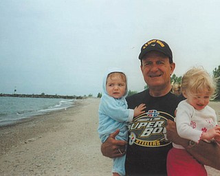 Bob DeFelice holds his 7-month-old grandson Caden and 21-month-old granddaughter Caylee in this photo taken in Geneva in May 2006.