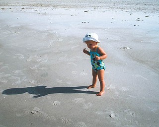 Hey, who's that shadow? Mena Monroe, 22 months, delights in having fun at St. Pete Beach in Florida. She's the granddaughter of Russell and Ellen Monroe of Austintown.