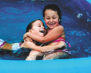 Cousins Hunter Oliva and Nevaeha Carcido have some water fun.