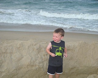 Nathaniel Reel, 3, of Hubbard, is proud of the large hole he dug with the help of his dad, David Reel, and Papa John Ruban. They were in Ocean City, Md., in July. Photo sent in by Elizabeth Reel of Hubbard.