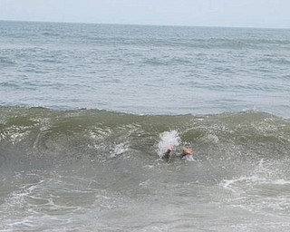 Ethan Parks of Greenford dives into a wave — notice the feet! Photo submitted by Dawn Dickey.