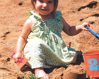 Audrey plays in the sand at Speece Lake in Berlin Center in July. Photo by Lana VanAuker of Canfield.