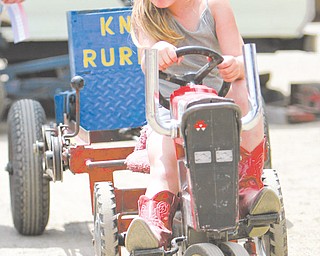 Myer Miller age 5 of Columbiana puts her pedal to the medal as she is in the Kid's Pedal Tractor Pull - she pulled the weights for 11 feet - Columbiana Fair est 1845 The Columbiana Fair is again on till Aug 5.