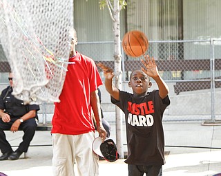 Mel Edwards, 9, shoots hoops in attempt to win a prize at the Greater Youngstown Italian Festival on August 4, 2012.