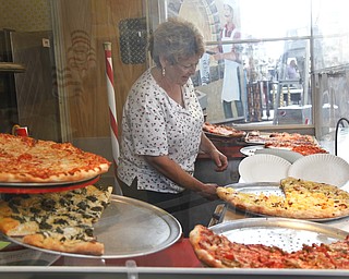 Rosemary Colaizzi works her pizza stand, Paisano's Pizza Connection, at the Greater Youngstown Italian Festival on August 4, 2012.