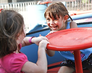 Caylee Wilkes, 3, and Arianna, 3, take a spin on a ride at the Greater Youngstown Italian Festival on August 4, 2012.