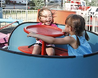 Caylee Wilkes, 3, and Arianna, 3, take a spin on a ride at the Greater Youngstown Italian Festival on August 4, 2012.