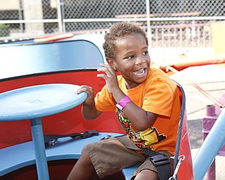 Xavier McDougald, 4, takes a spin on a ride with his brother at the Greater Youngstown Italian Festival on August 4, 2012.