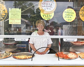 Rosemary Colaizzi works her pizza stand, Paisano's Pizza Connection, at the Greater Youngstown Italian Festival on August 4, 2012.