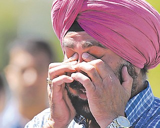 A man reacts outside the Sikh Temple of Wisconsin to a shooting there that killed at least six.