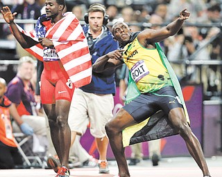American Justin Gatlin, left, and Jamaica’s Usain Bolt celebrate their medal-winning performances in the 100-meter dash during Day 9 of competition at the 2012 Summer Olympics in London. Bolt raced to a gold, joining Carl Lewis as only men to repeat as 100-meter champs. Gatlin earned bronze.