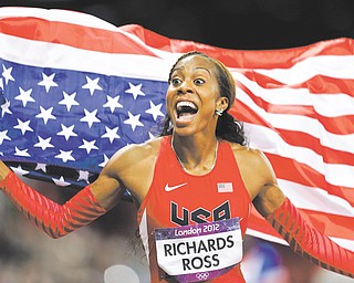 Sanya Richards-Ross waves the American flag after winning the women’s 400-meter during Day 9 of competition at the 2012 Summer Olympics in London. Compatriot Deedee Trotter joined Richards-Ross on the podium as the bronze-medal winner.