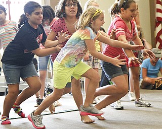 (L-R) Erin Jackson, 9, of Boardman, Emily Jackson, 11, of Poland, Ava Bosnjak, 6, of Poland, and Kyla Jackson, 11, of Struthers, run to collect eggs during a 'Live Pacman' game held by the Boardman Library on August 9, 2012.