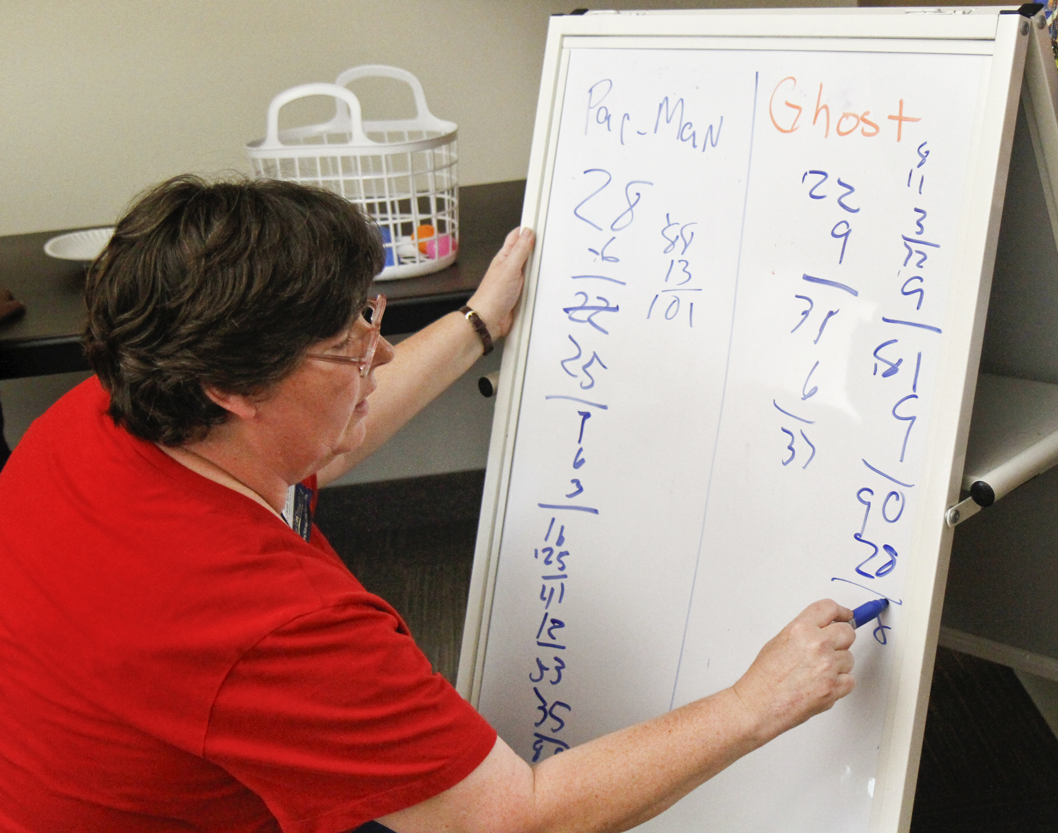 Karen Saunders of Boardman, Ohio tallies the points between the Pacman group and the Ghost group during the 'Live Pacman' game hosted by the Boardman Library on August 9, 2012. 