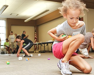Anabella Soanes-Carter, 9, of Boardman, Ohio collects eggs during the 'Live Pacman' game at the Boardman Library on August 9, 2012.